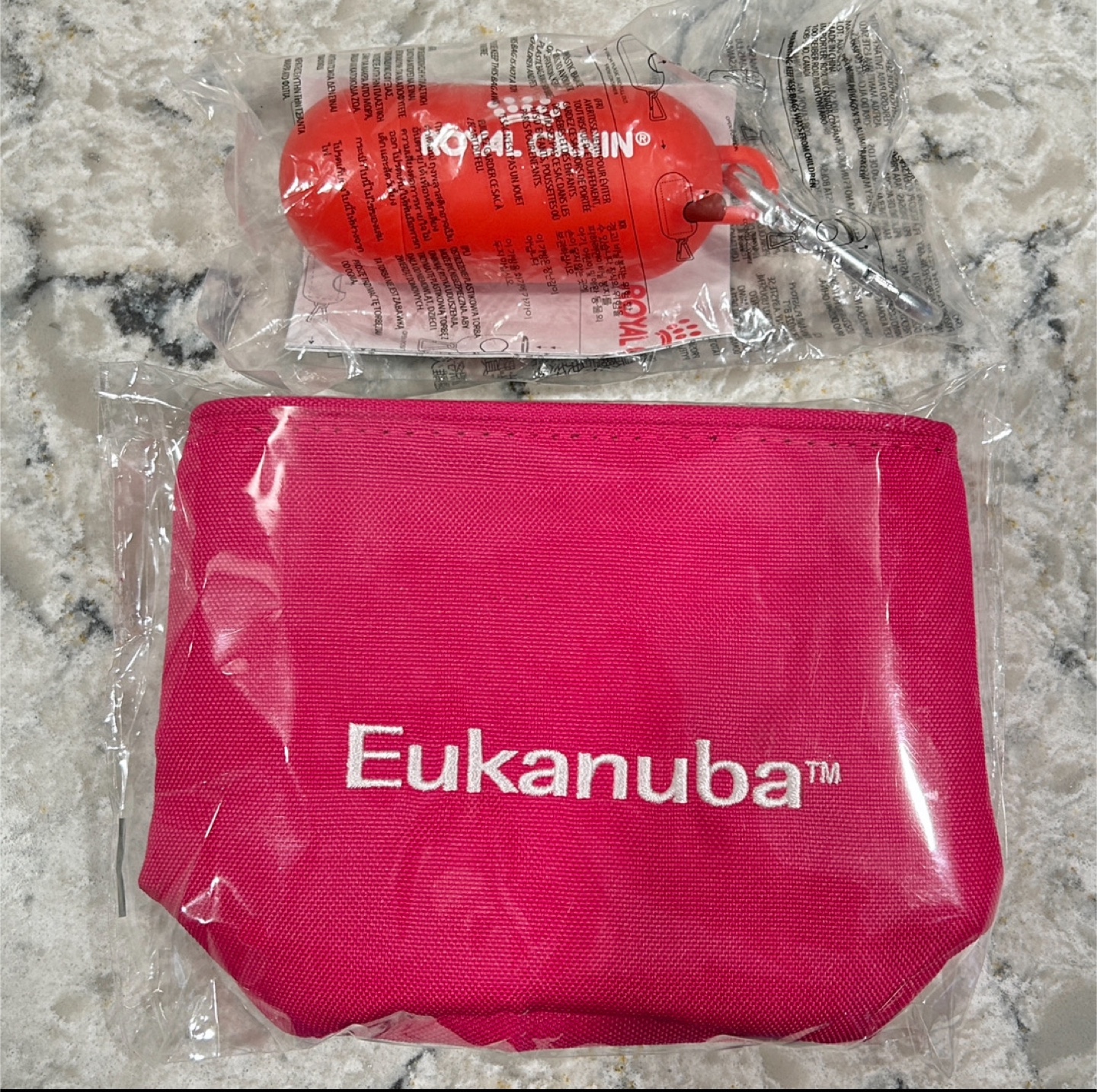 Pink Treat Pouch and Red/Orange Plastic Poop Bag Holder