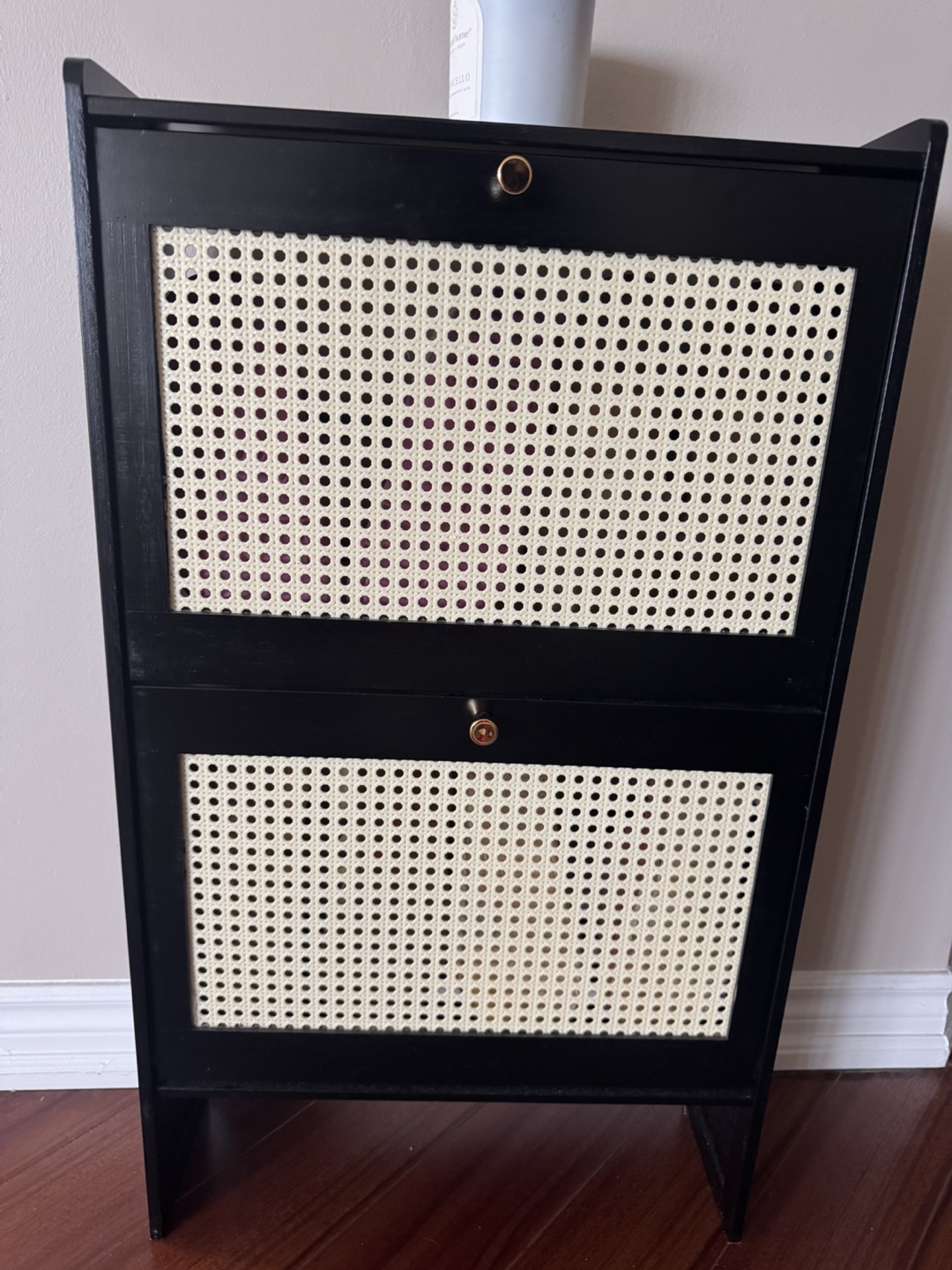 Stylish black shoe cabinet with rattan-style front panels