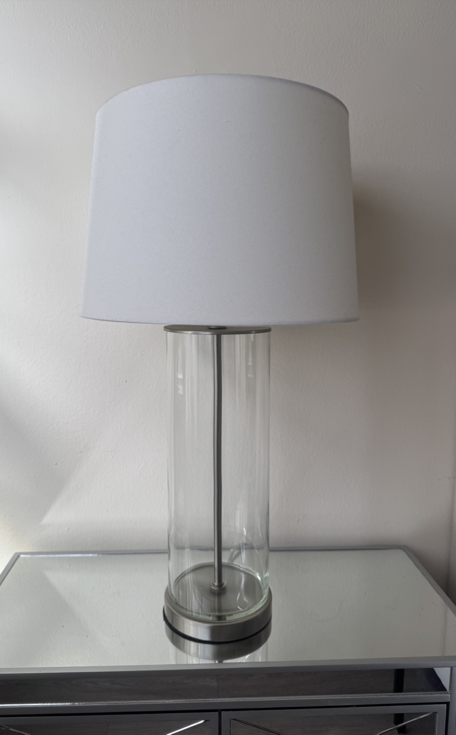 There’s two of them Glass Cylinder Table Lamp with White Shade