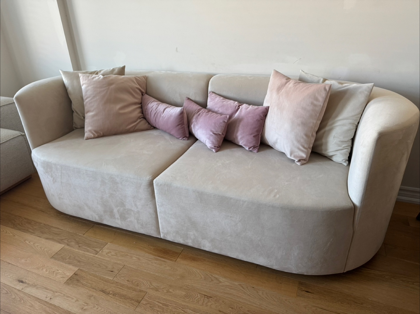 Beige Curved Sofa with Pillows