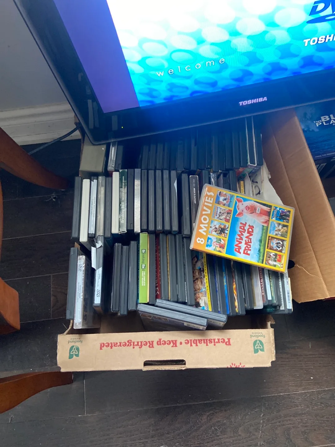 Tv with dvd player inserted and DVD  collection image indicator(3)