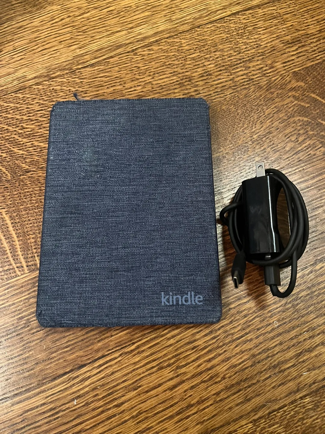 11th generation Kindle with blue cover and charging chord thumbnail
