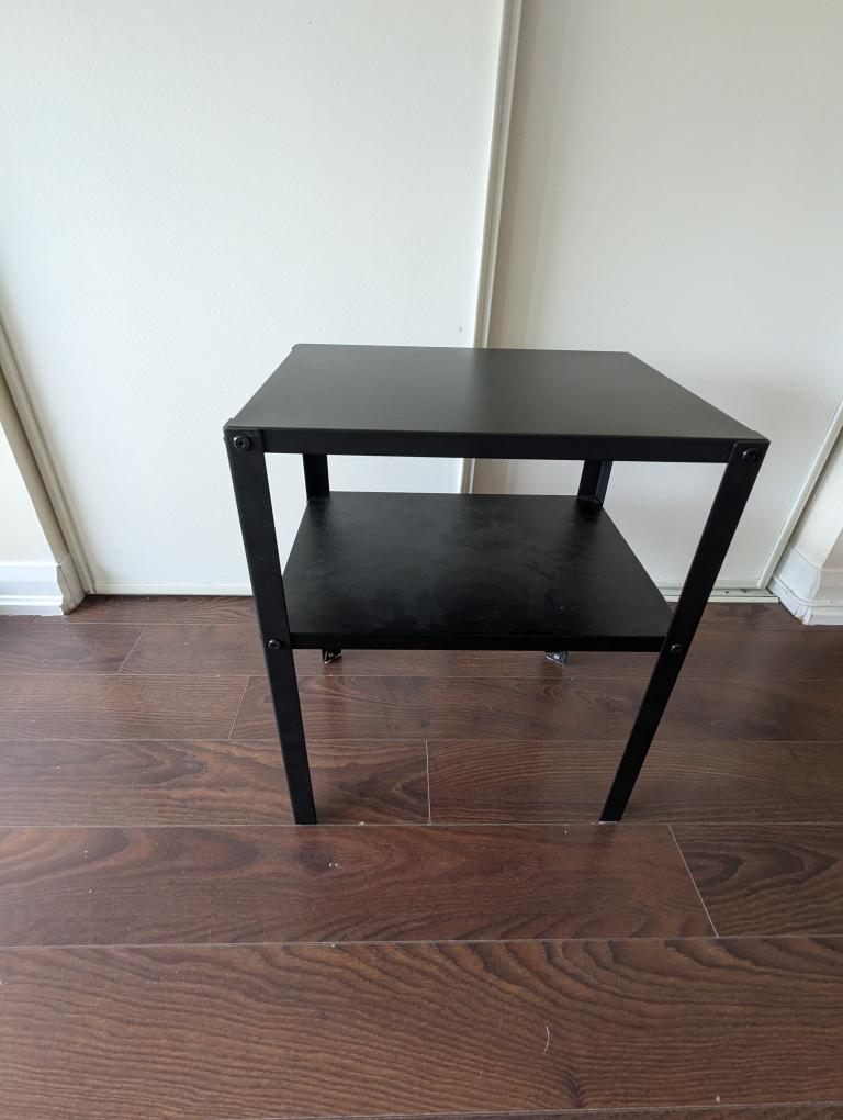 One black IKEA knarrrevik bedside table.