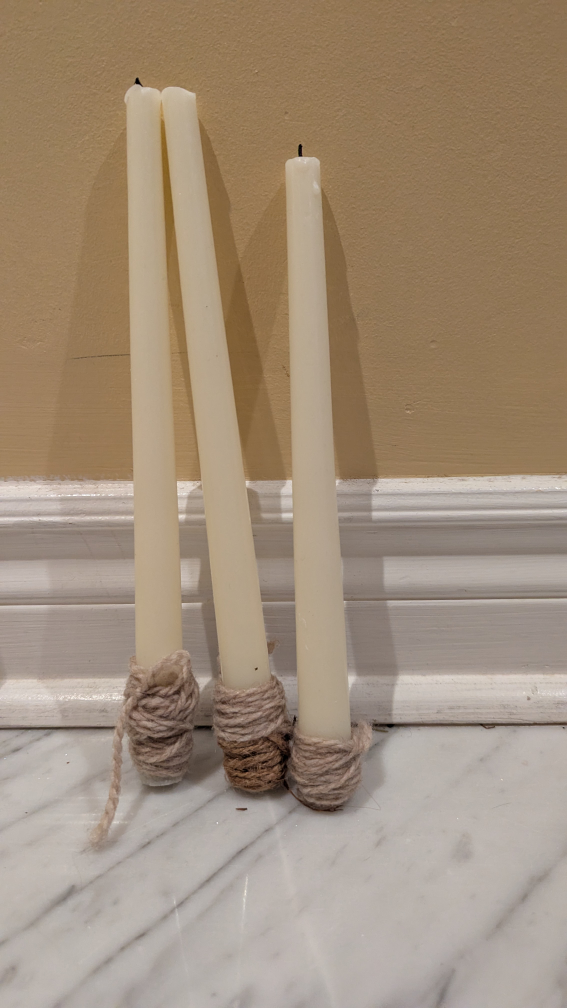 three cream coloured tall candles