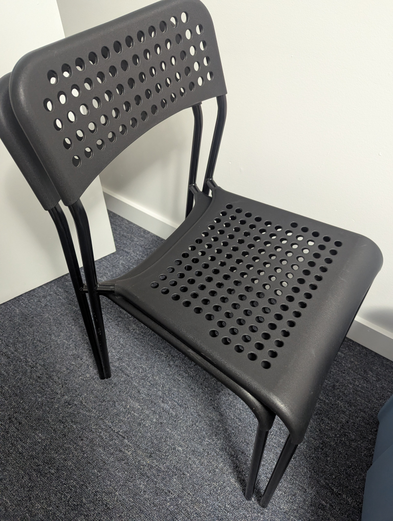 2 black Ikea Adde chairs