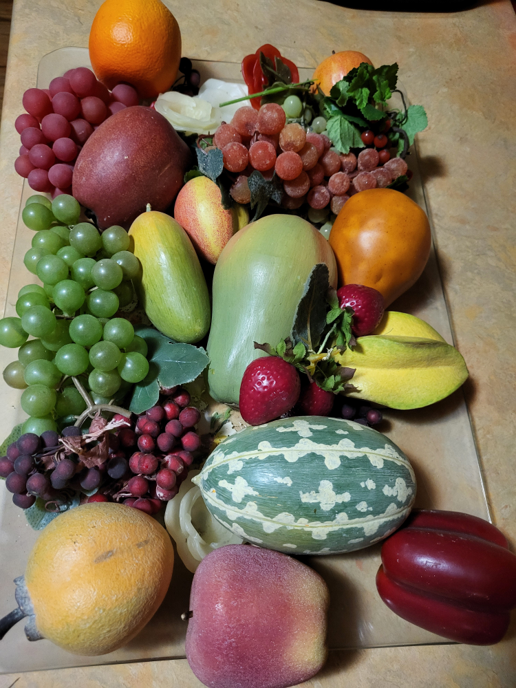 A dish of decorative fake fruits