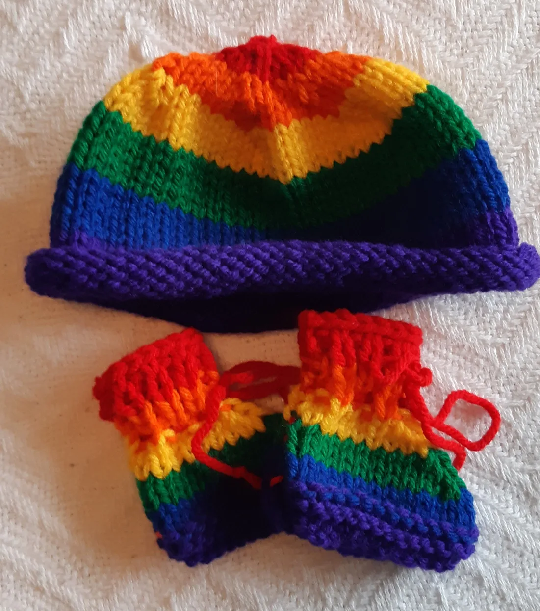 handmade baby booties and hat set in rainbow colours thumbnail