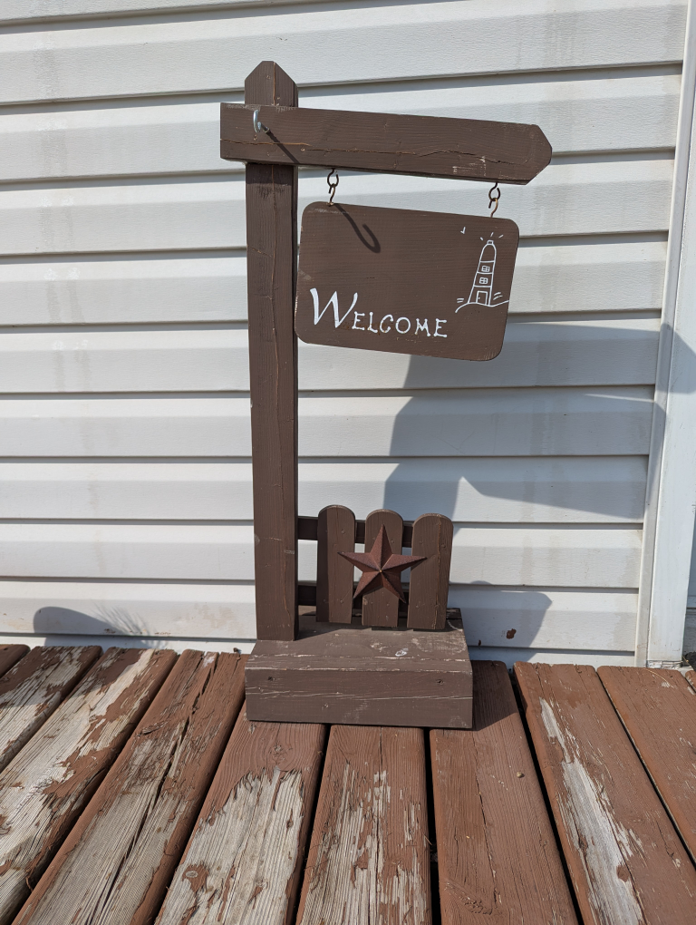 Brown Welcome Sign with Lighthouse