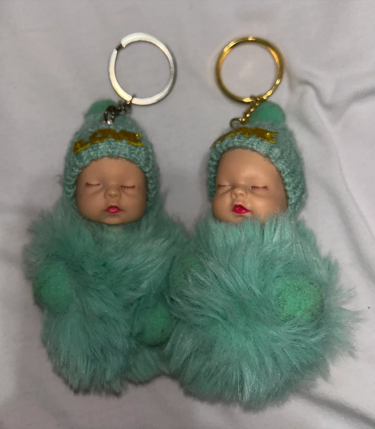 Two Turquoise Fluffy Keychain Baby Dolls thumbnail