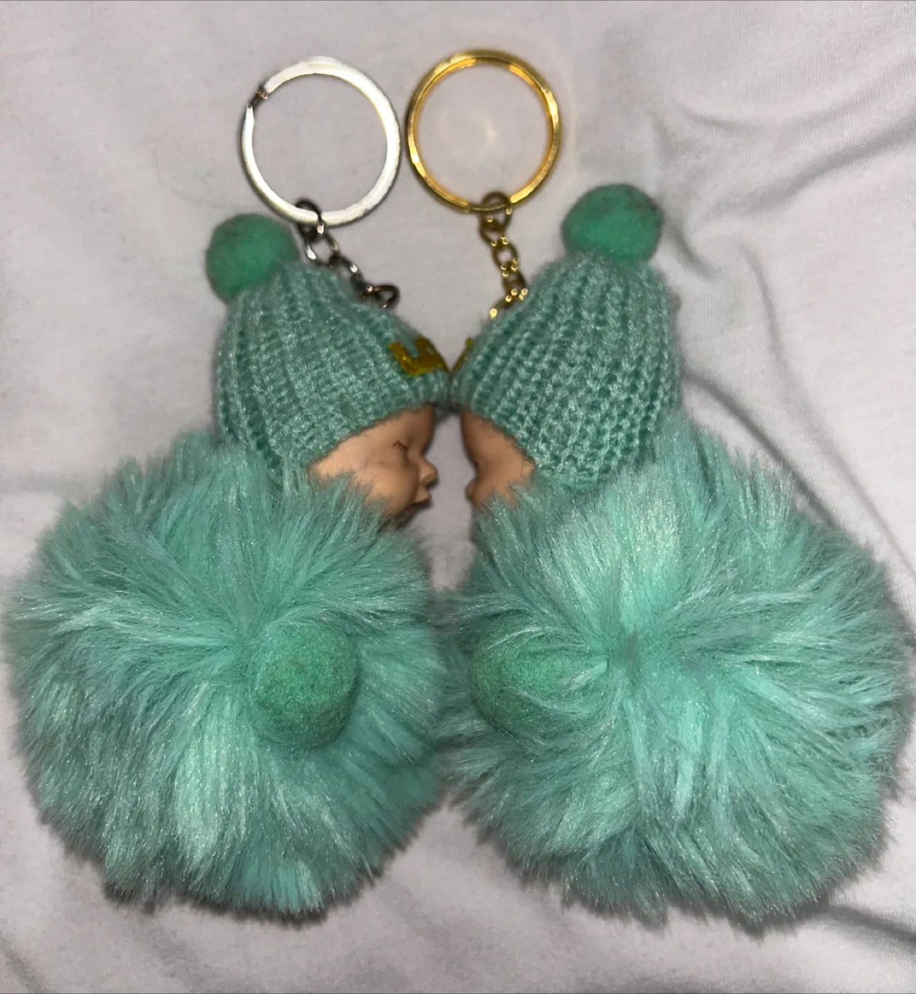 Two Turquoise Fluffy Keychain Baby Dolls image indicator(2)
