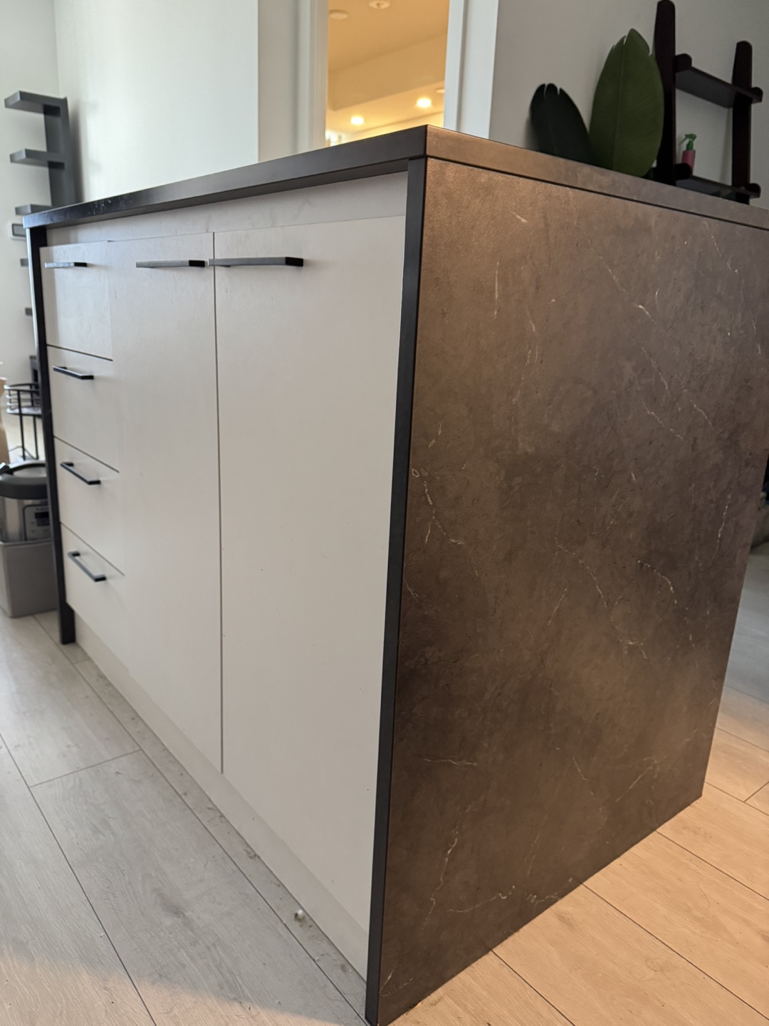 Kitchen Island with White Cabinets and Dark Countertop