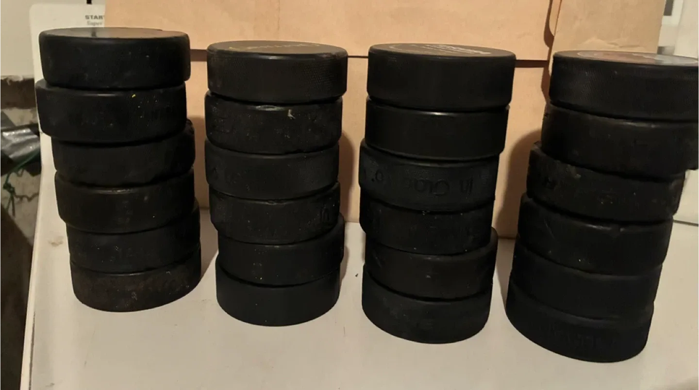 24 Used Hockey Pucks