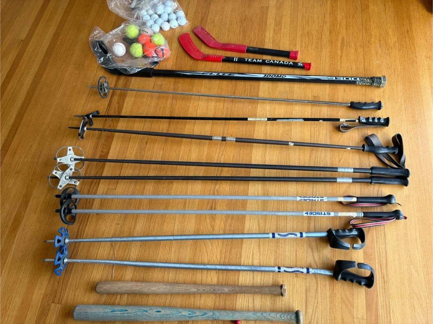 Mixed Lot: Ski Poles, Hockey Sticks, and Baseball Bats thumbnail