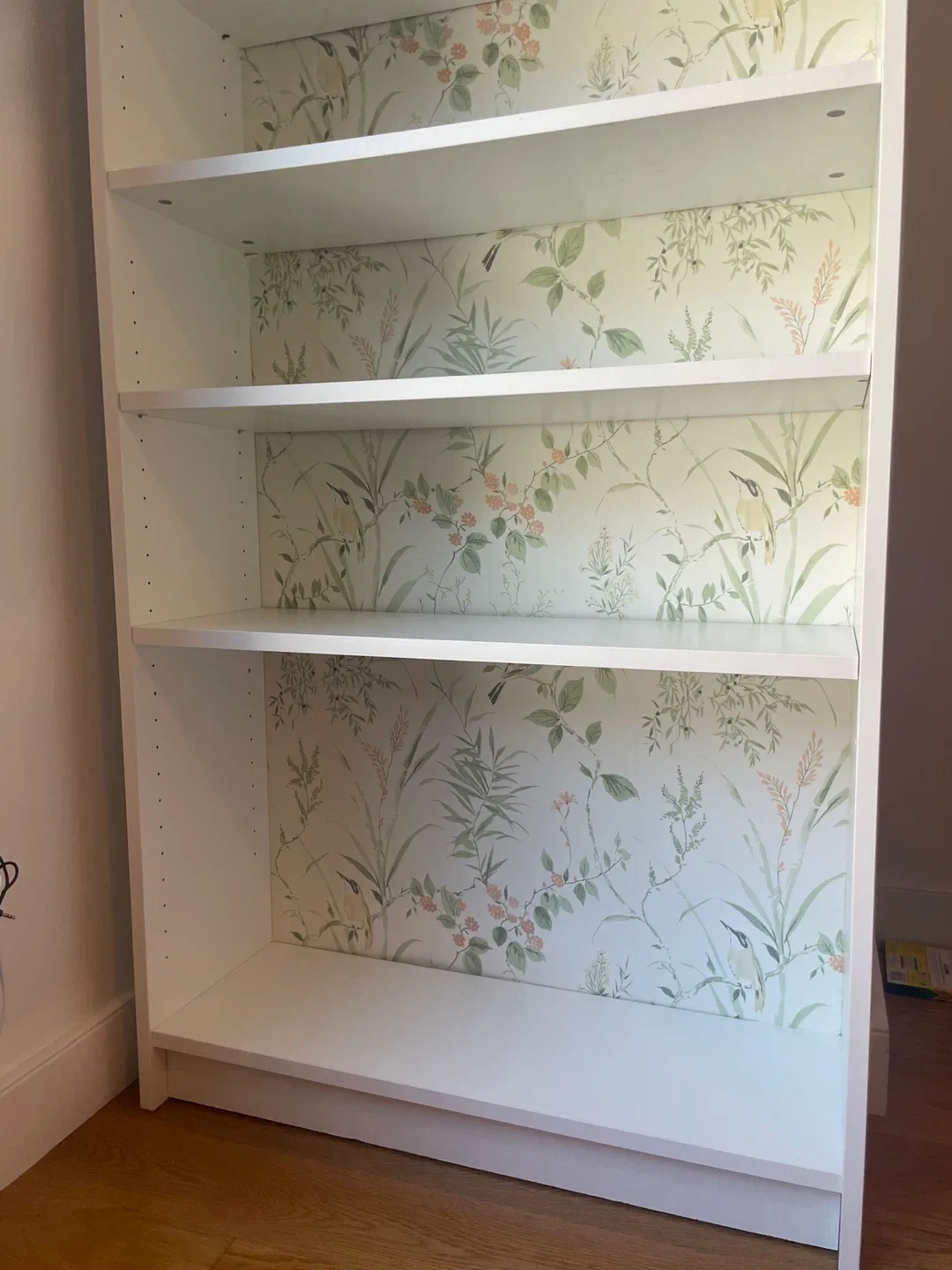 White bookcase with garden print accent image indicator(4)