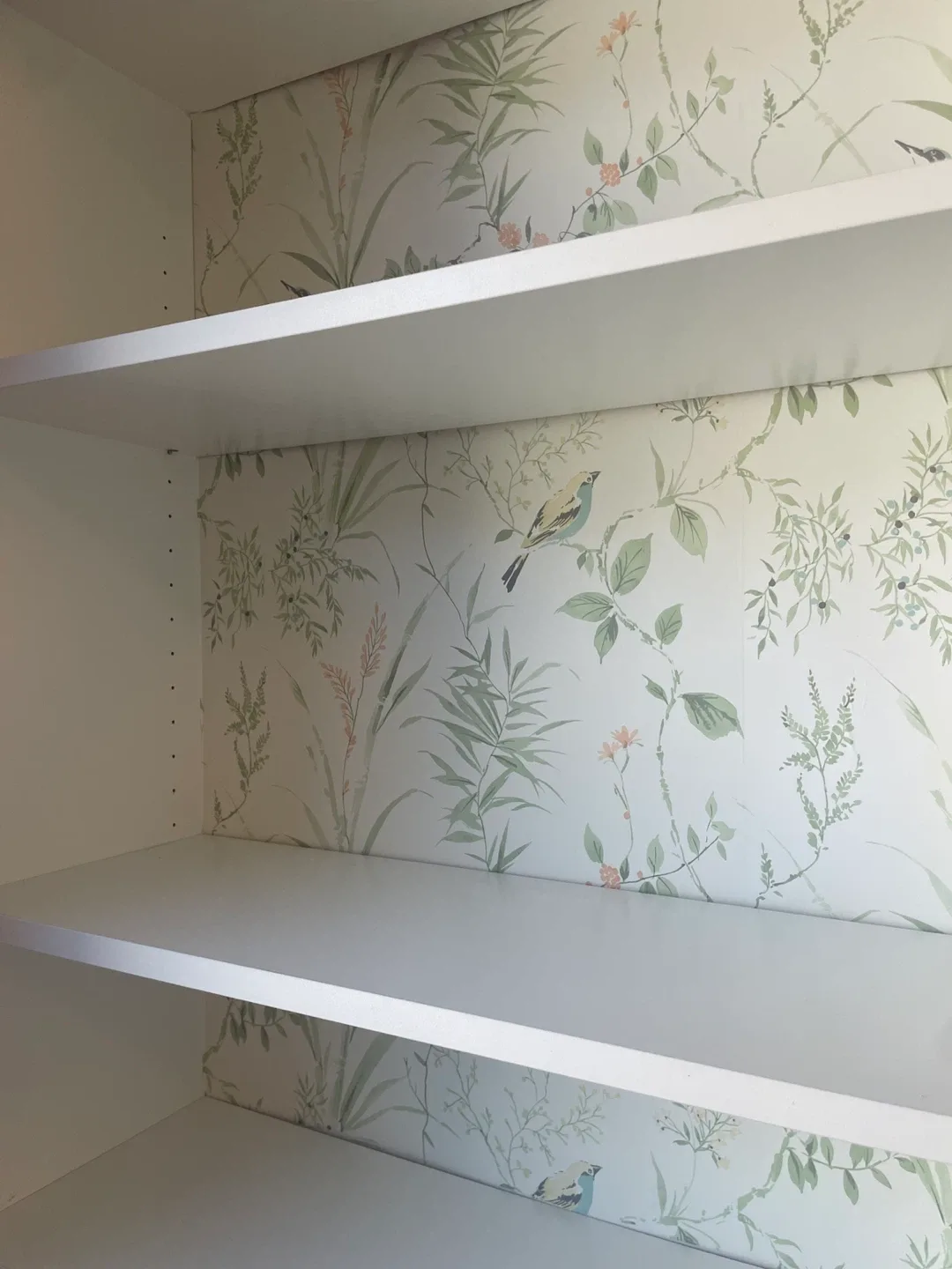 White bookcase with garden print accent image indicator(5)