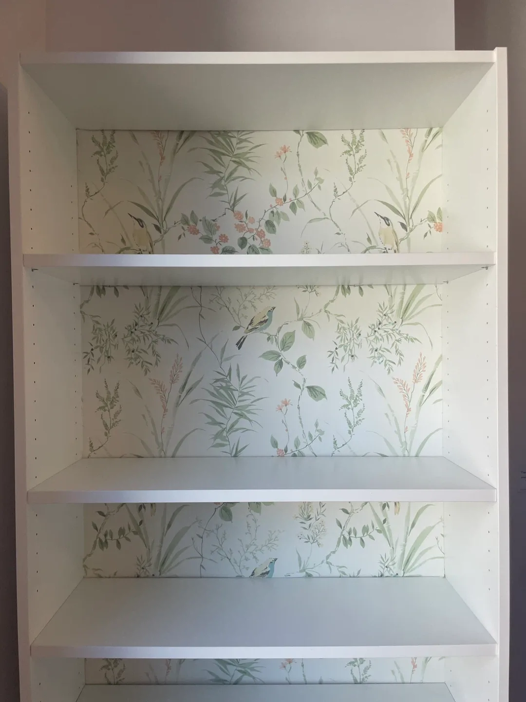 White bookcase with garden print accent image indicator(3)
