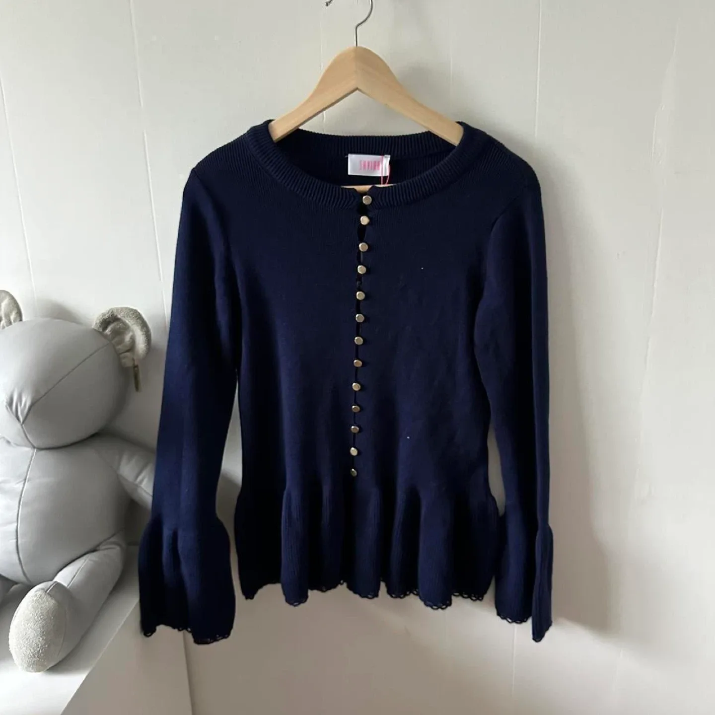 Navy blue button up sweater with bell sleeves and gold buttons