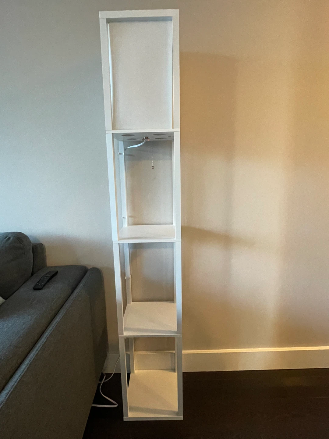 Three white floor lamps with shelves
