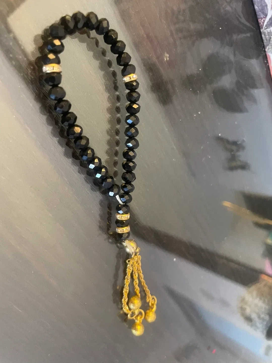 Black Beaded Bracelet with Gold Tassels thumbnail