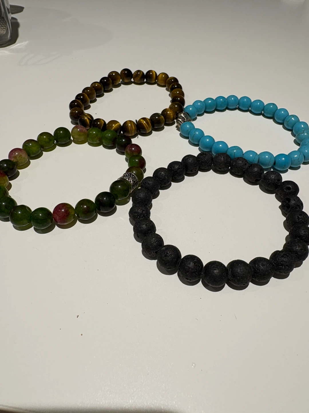 4 bracelets and a jar of mixed pendants and necklaces - photo 2