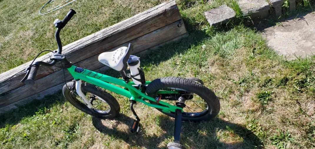 Green kids bike with training wheels image indicator(3)