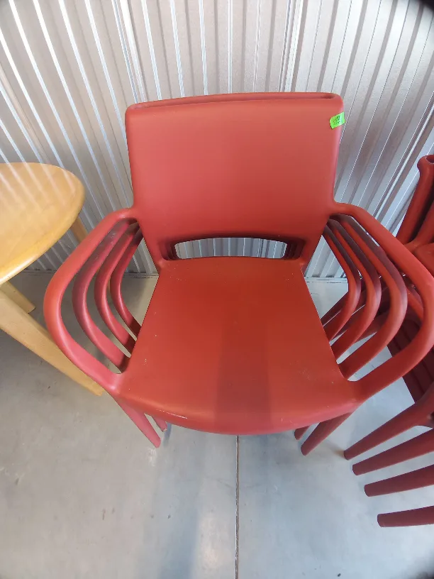 7 Solid plastic Brick Red Stackable Chairs for outdoors