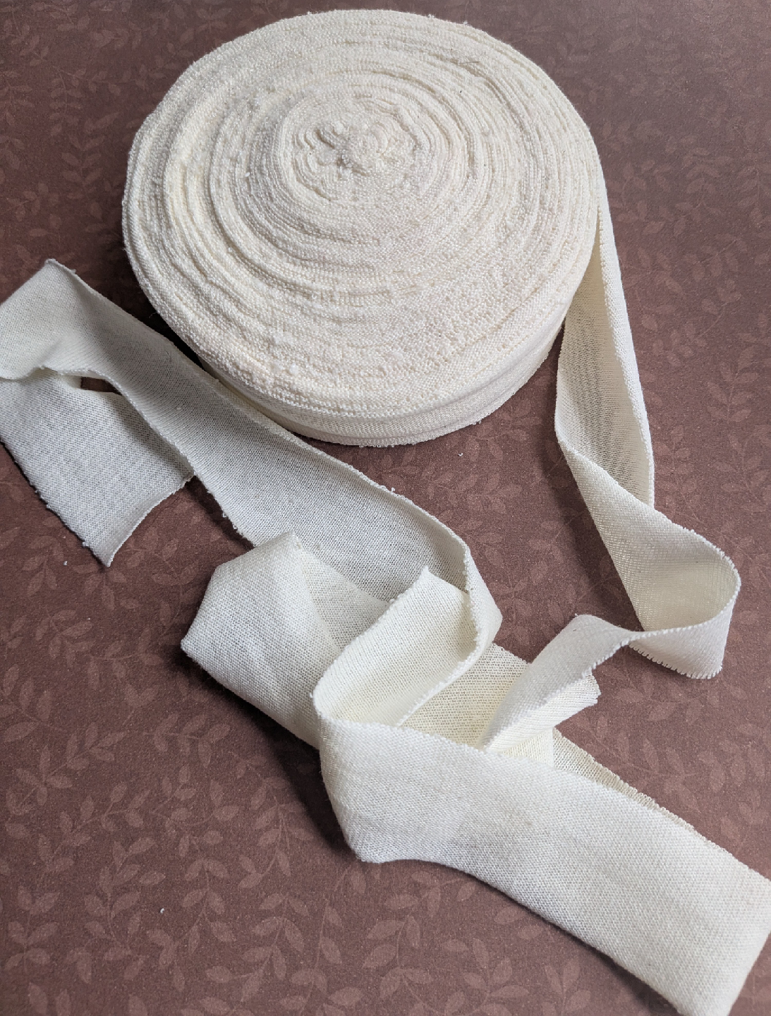 Roll of Cream-Coloured jersey knit trim