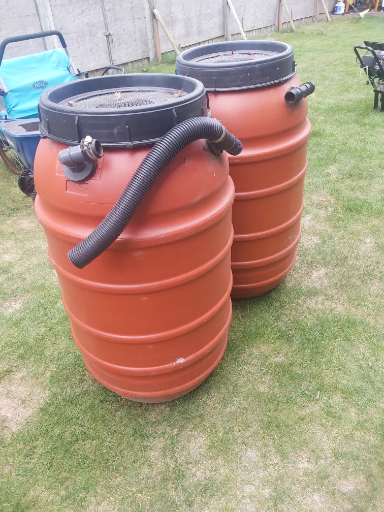 Two Orange Plastic Rain Barrels thumbnail