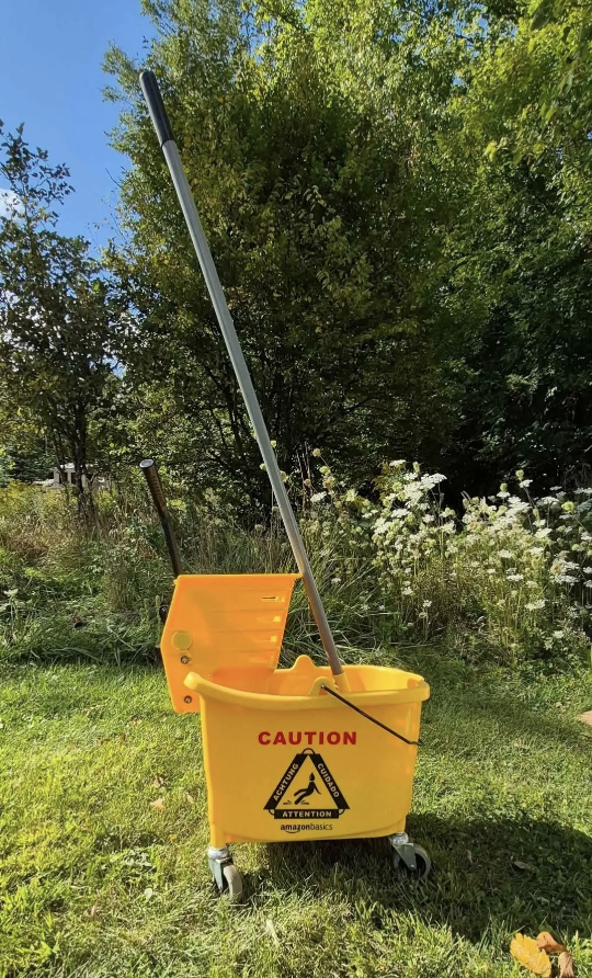 commercial-style yellow mop bucket