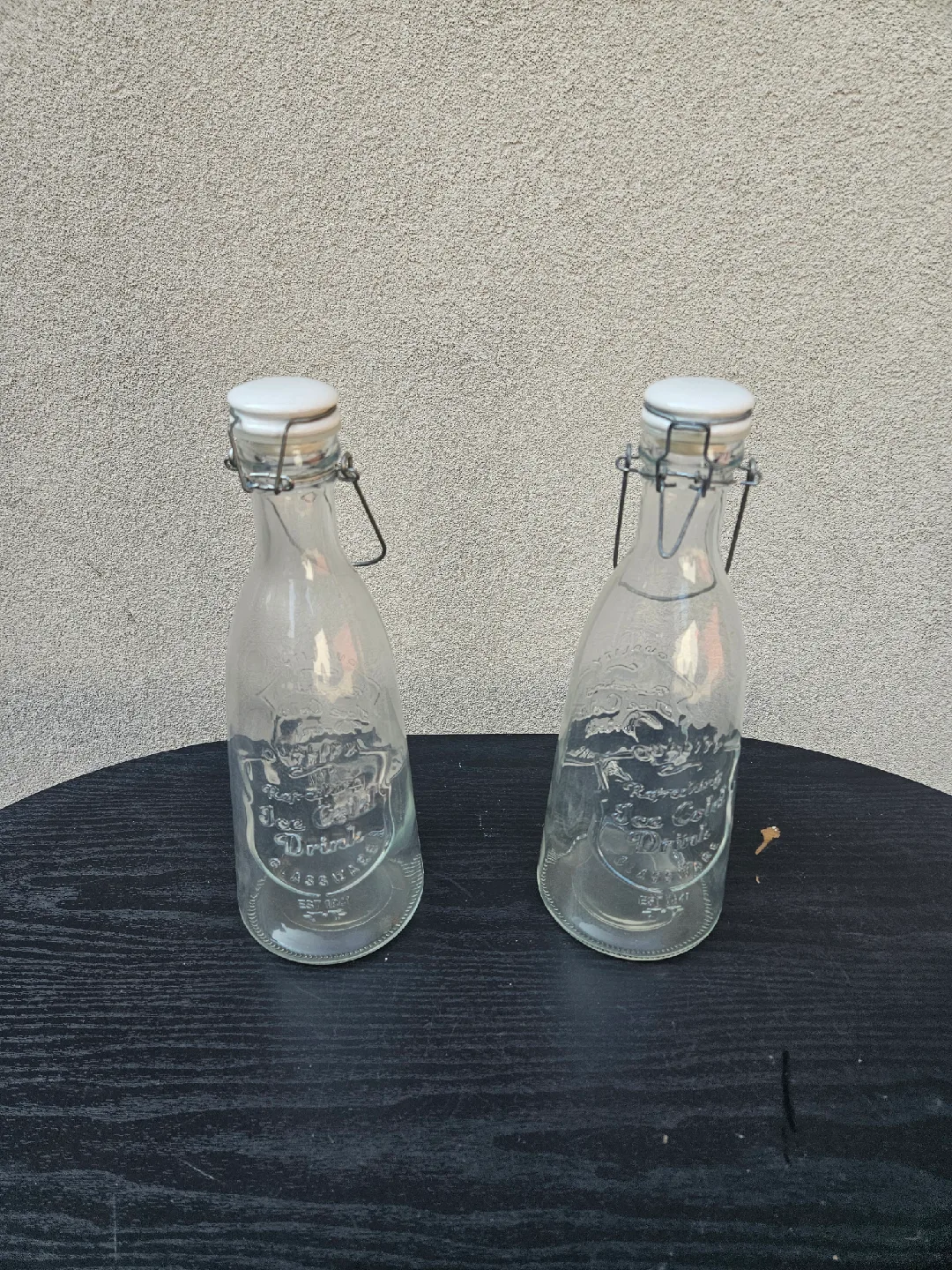 Two Glass Bottles with White Stoppers thumbnail