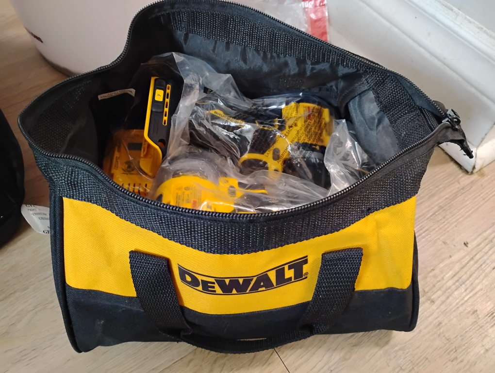 bag of brand new drills battery and charger
