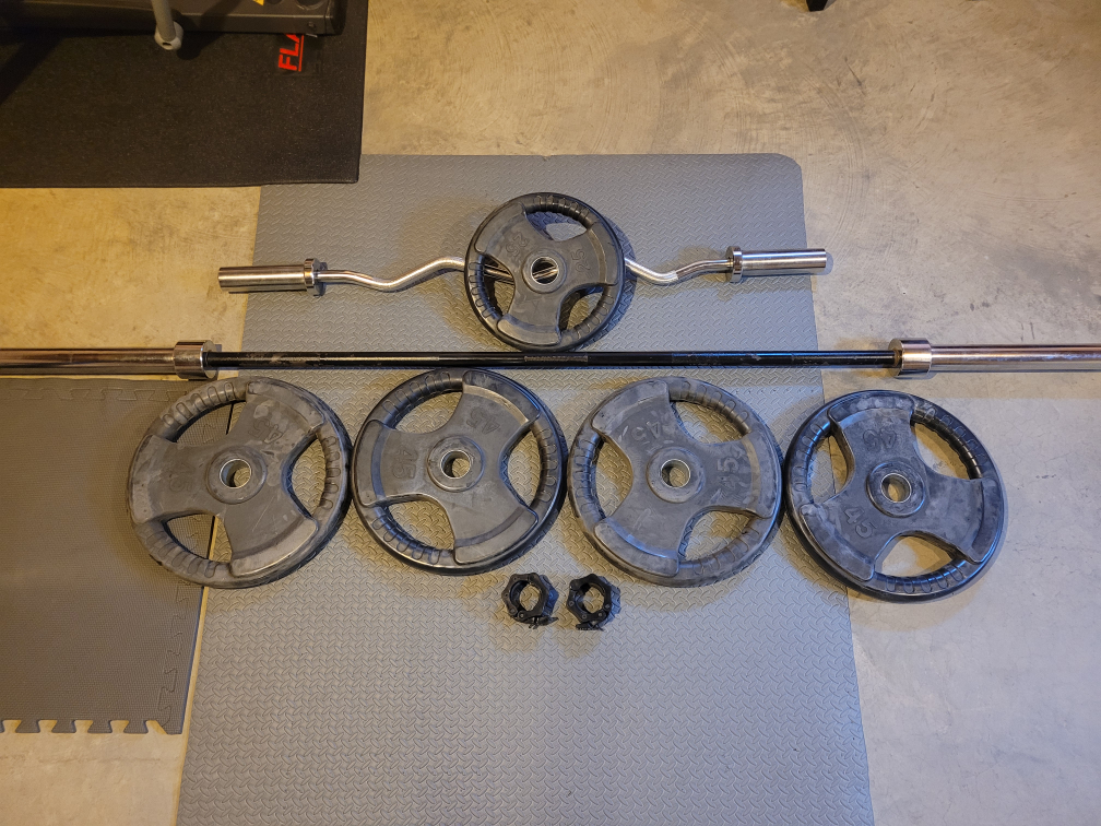 Barbell, Preacher Bar, and Weight Plates with Stand.