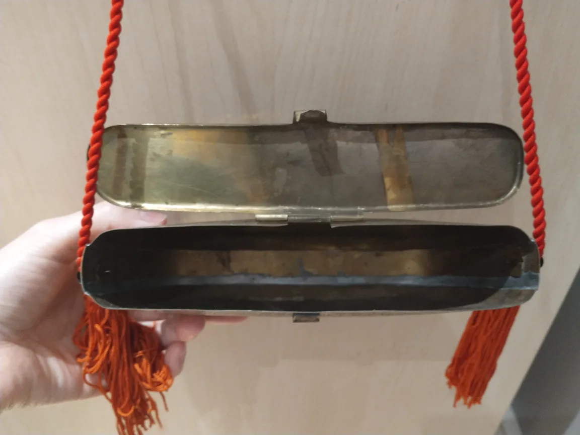 Antique bronze metal clutch bag with red tassles image indicator(3)