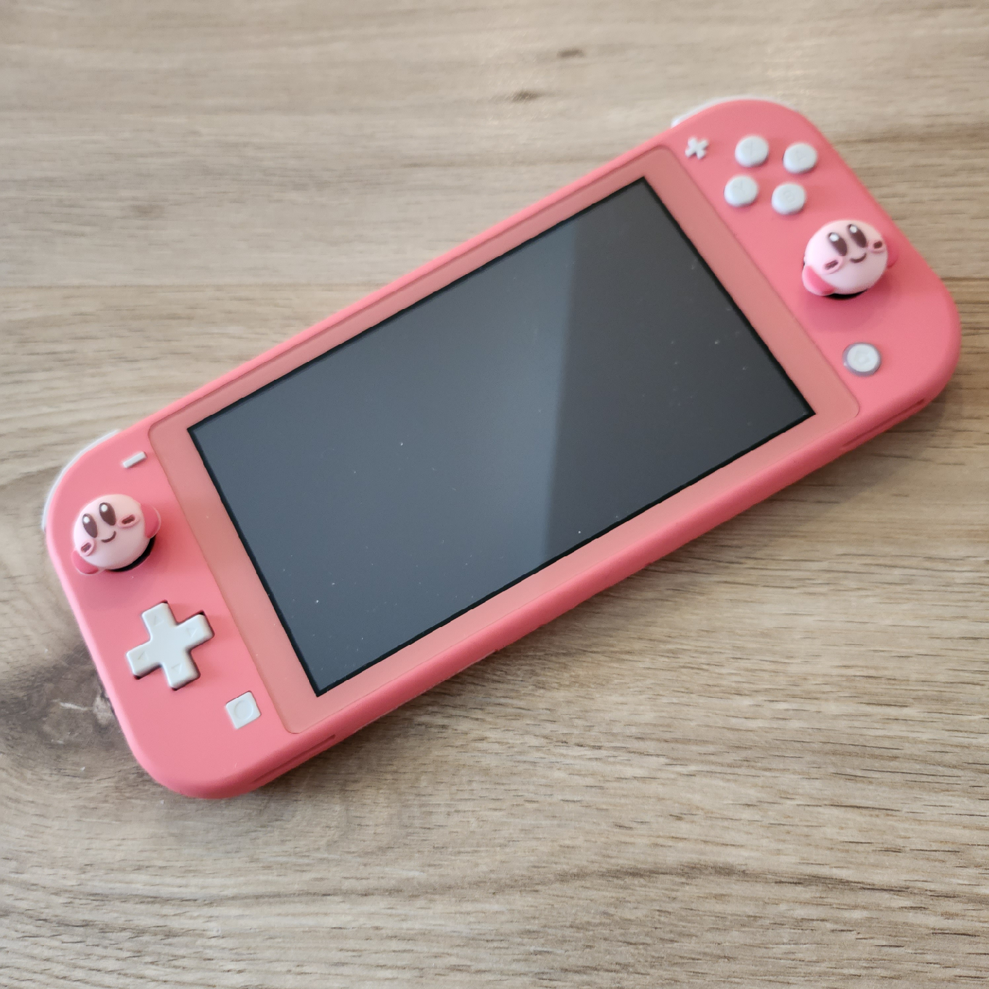 Nintendo Switch Lite Coral with Kirby Thumb Grips