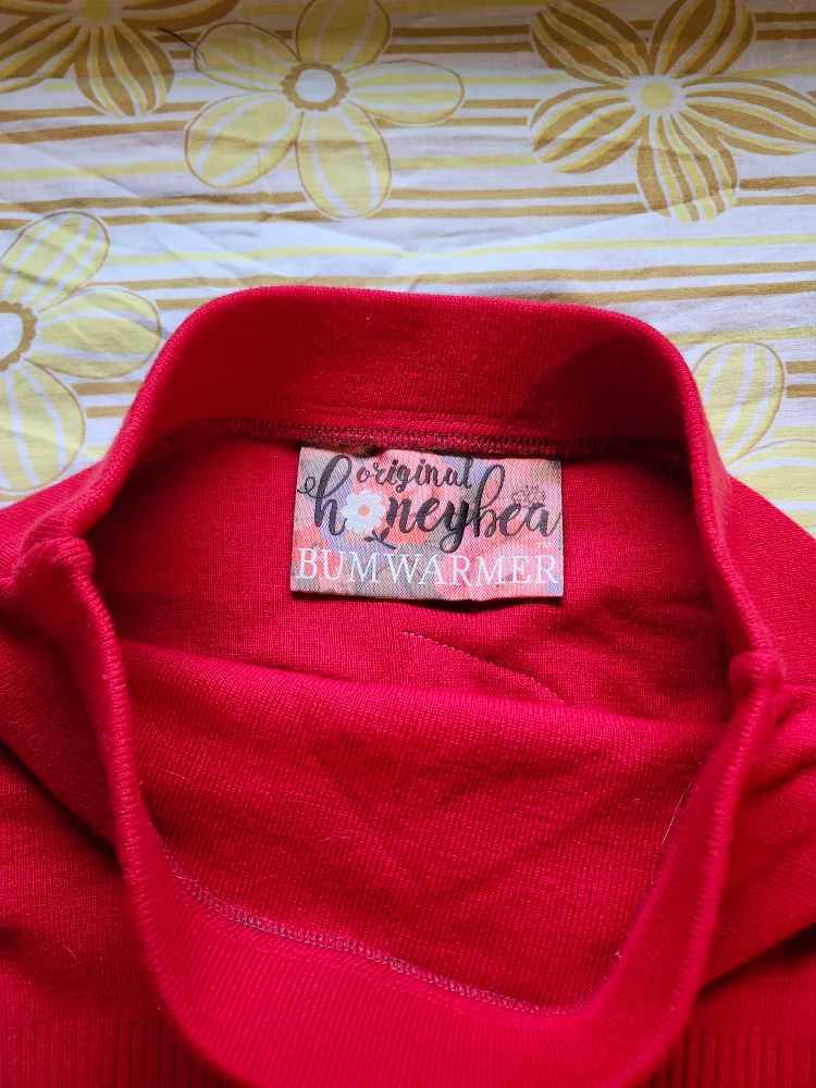 Red and black Bum Warmer mini sweater skirt with flower detail image indicator(5)