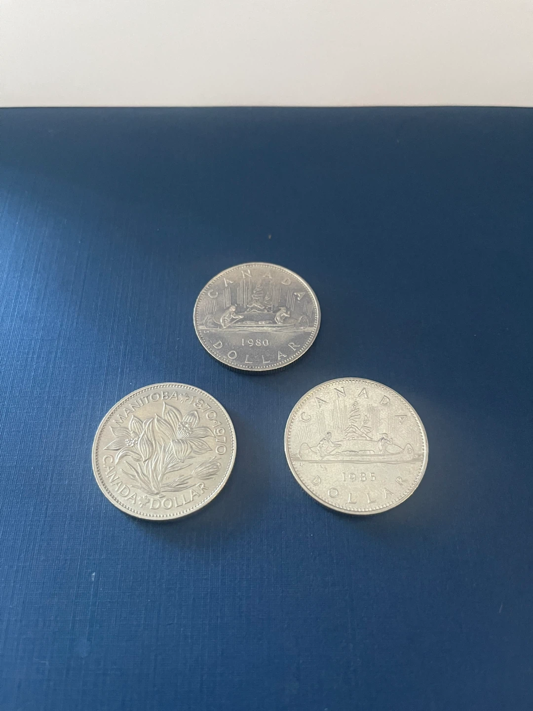 Three old Canadian dollars