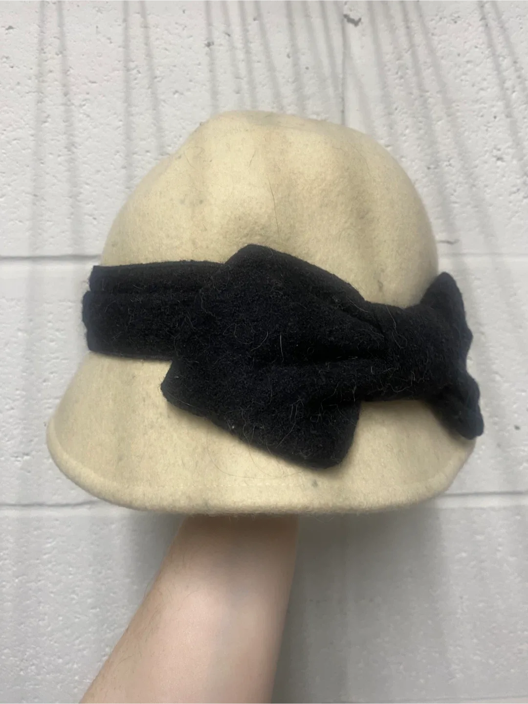 Cream cloche hat with black bow accent