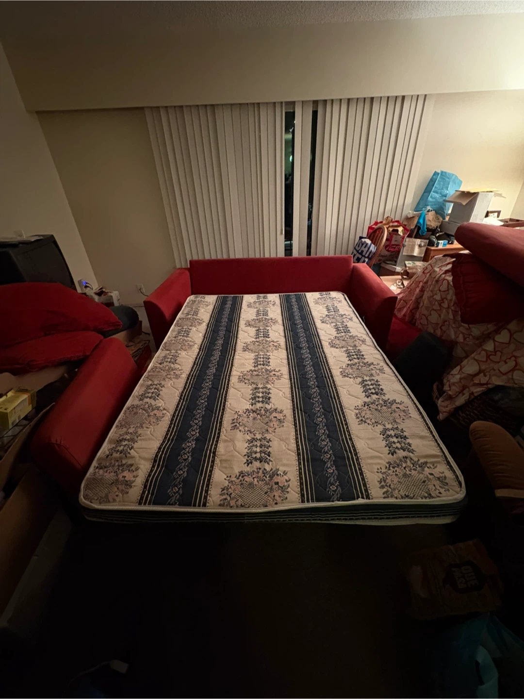 Red Two-Seater Sofabed with Bolster Pillows