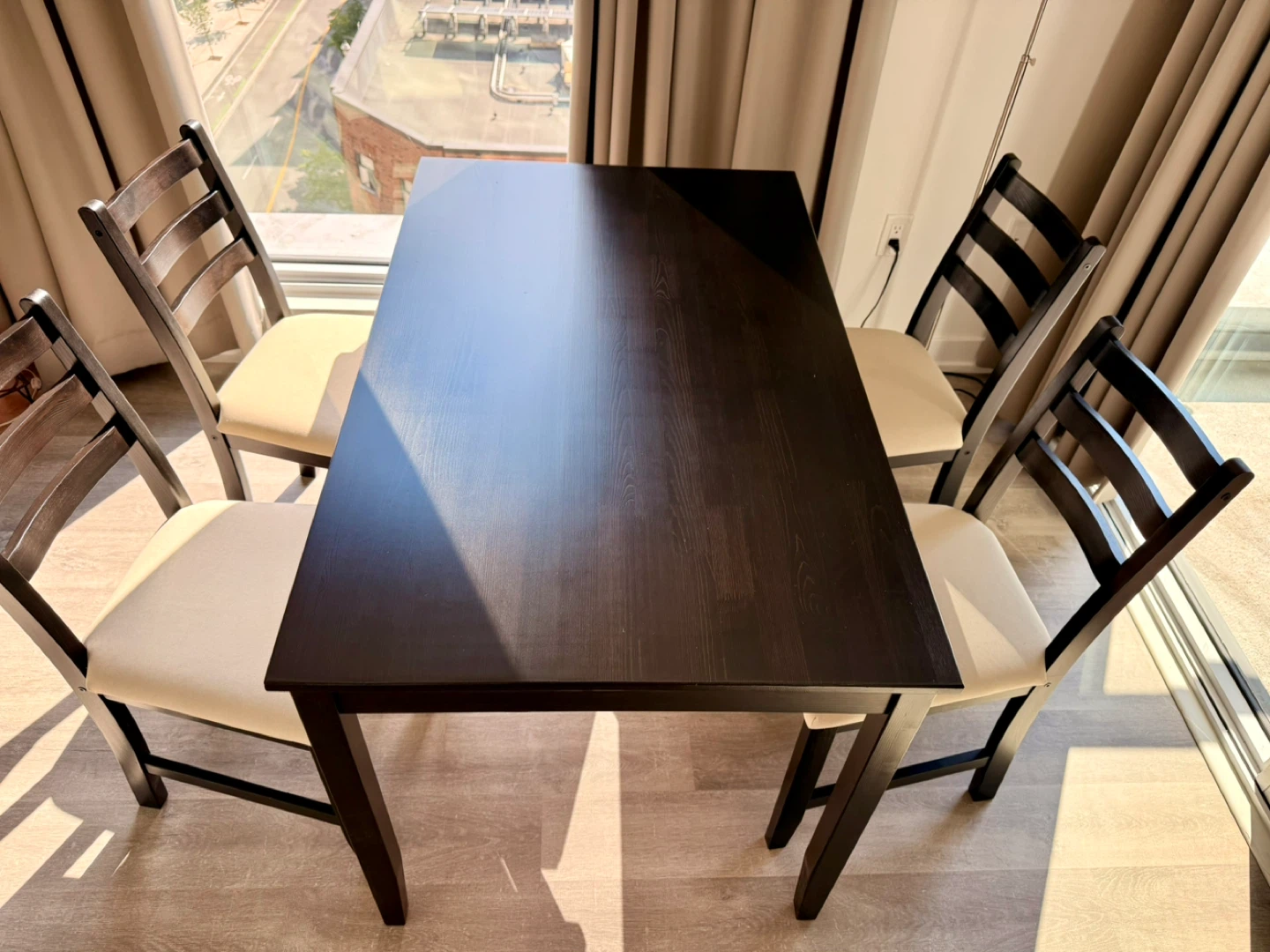 IKEA Black Dining Table with White Cushioned Chairs(4)