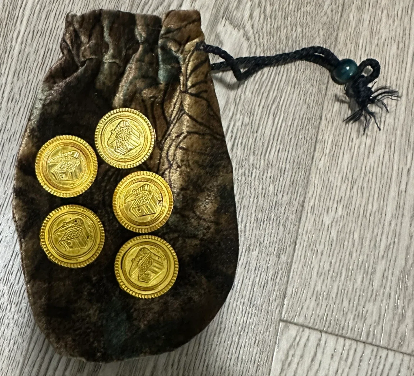 Pirate doubloons in a velvet pouch image indicator(2)