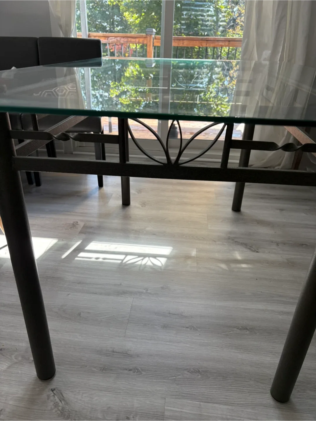 Glass top dining table with iron wrought base image indicator(2)