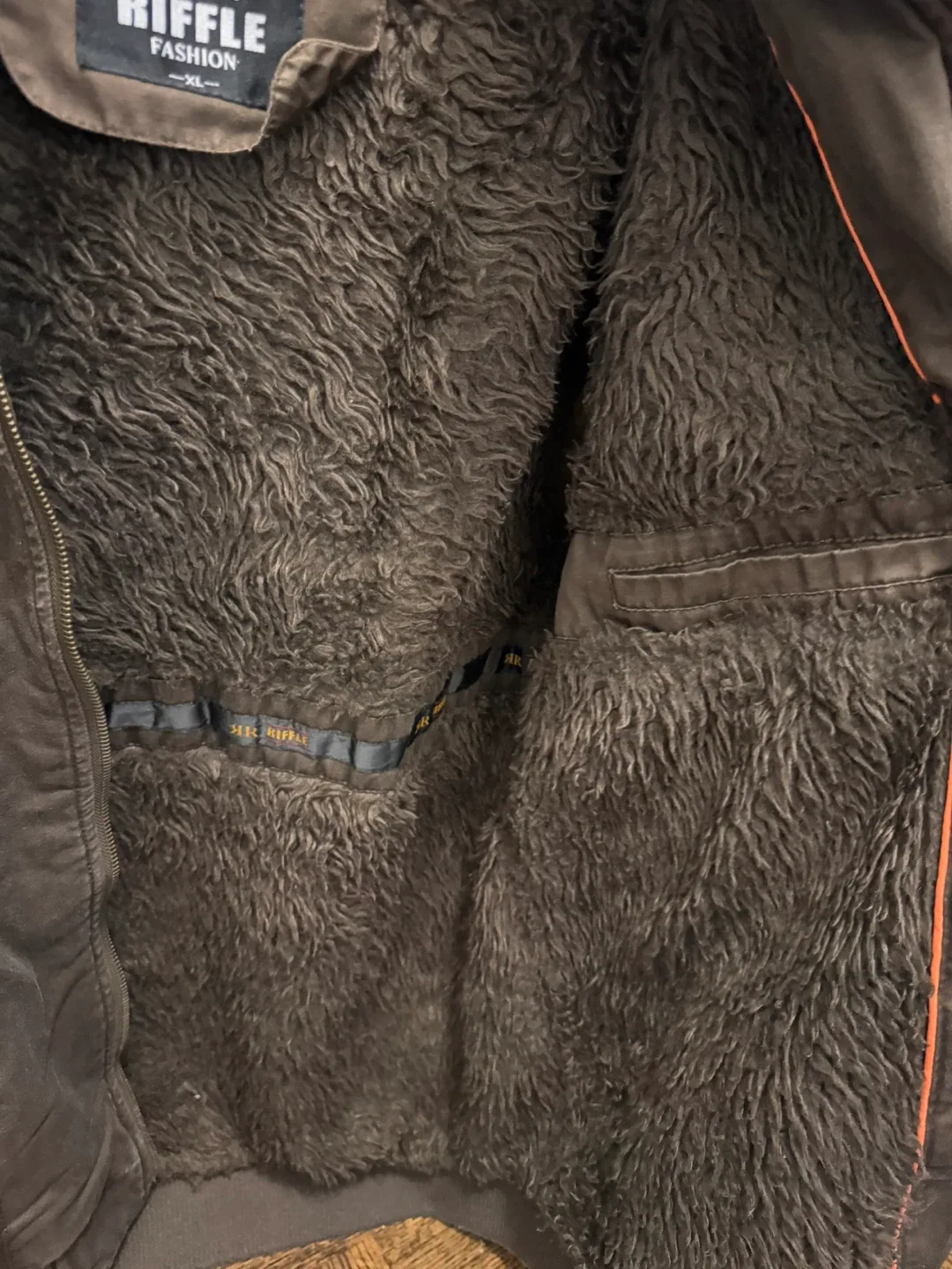 Brown jacket with faux-shearling lining for warmth image indicator(3)