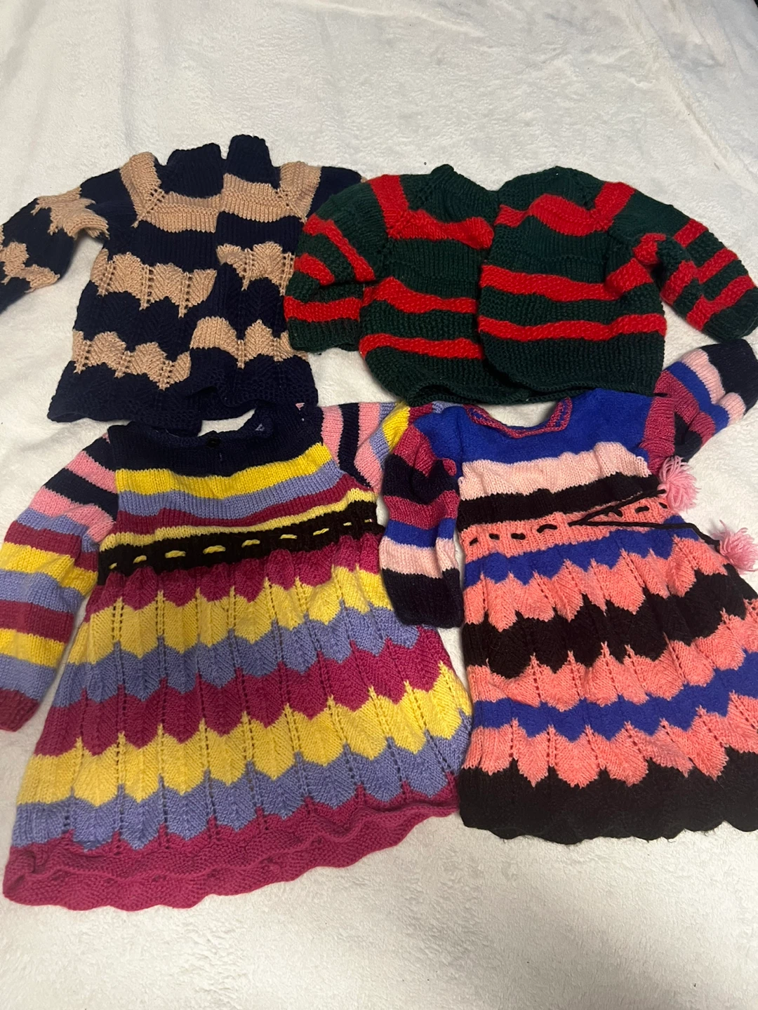 Hand-Knitted Baby Sweaters and Dresses