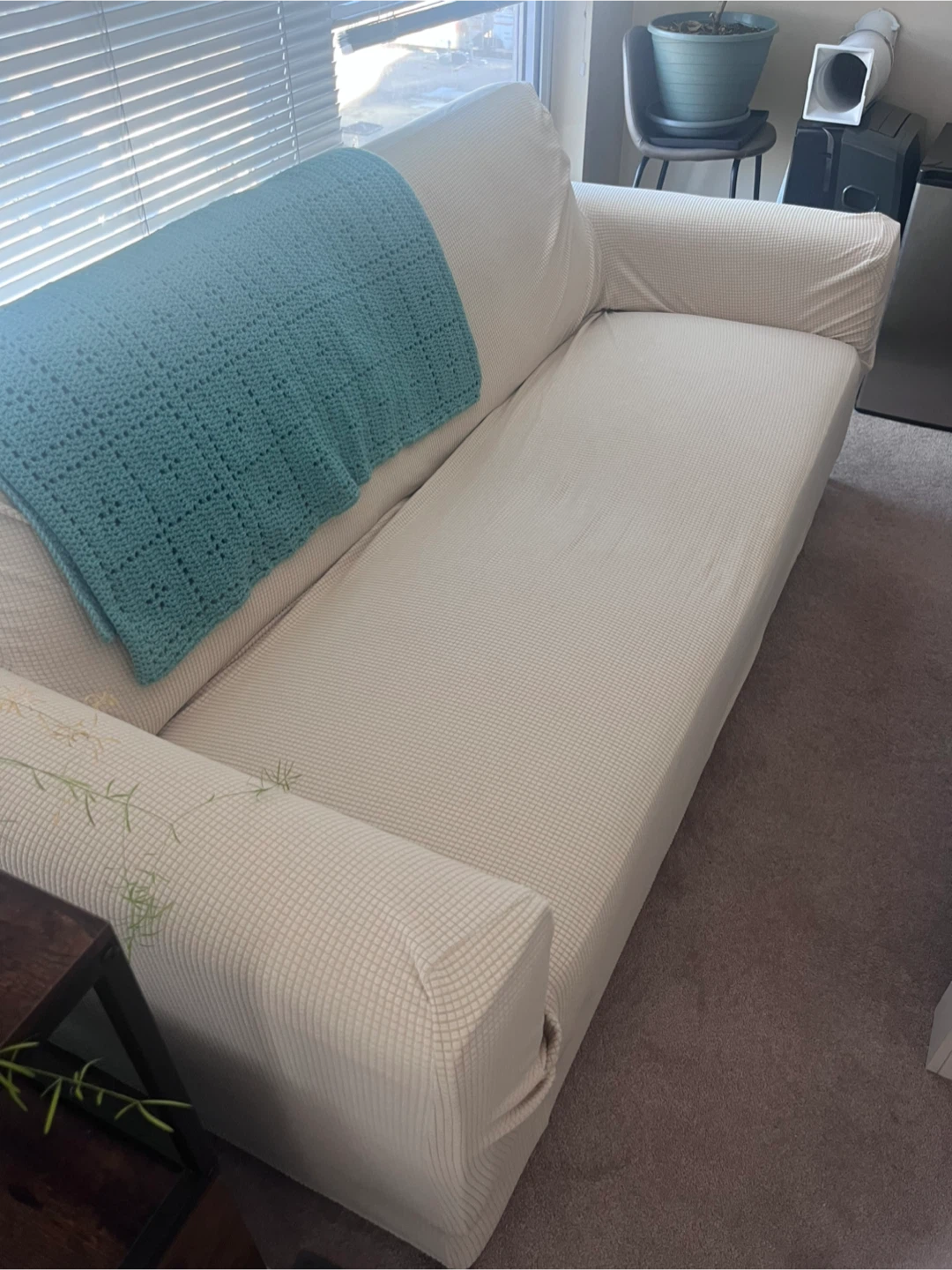 White sofa with beige sofa cover