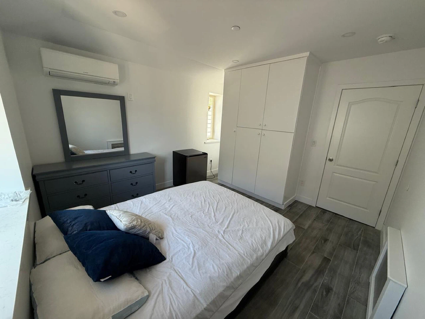 Bedroom set with dresser, mirror, and mini fridge