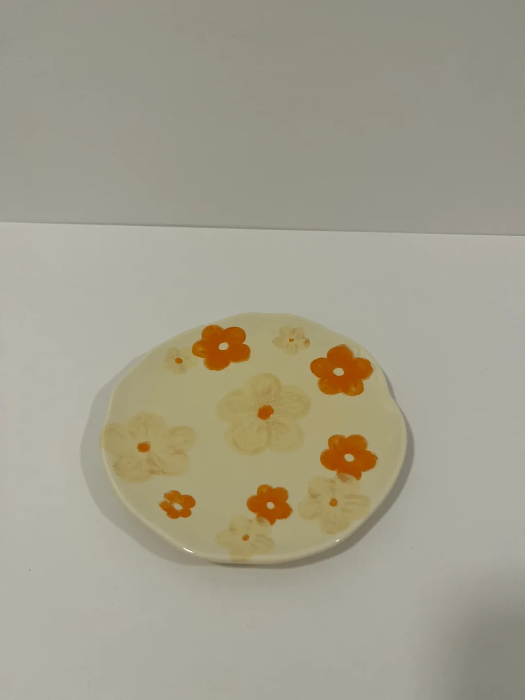 Saucer with orange floral print