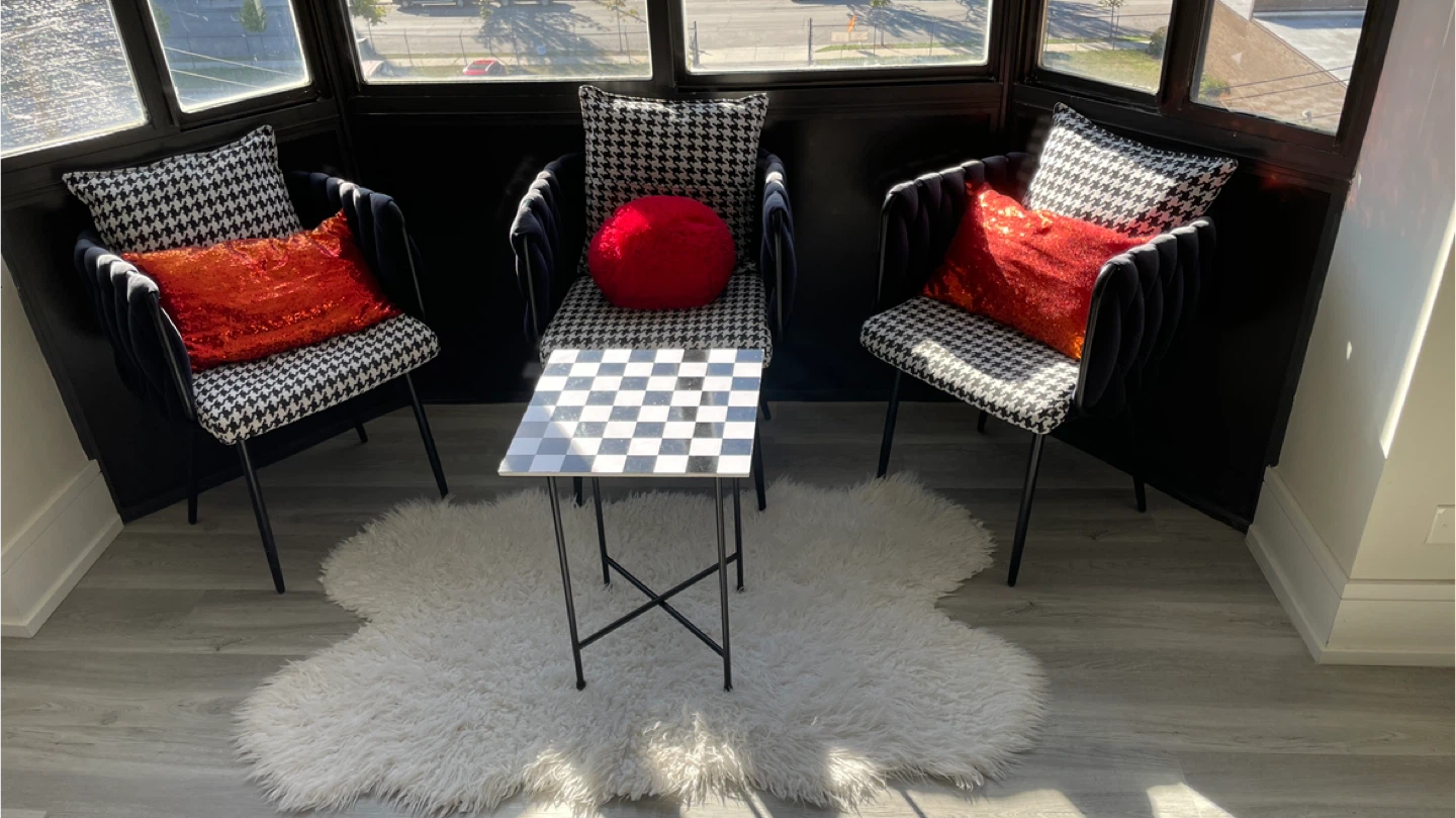 A modern seating area with a stylish table and chairs. - photo 2