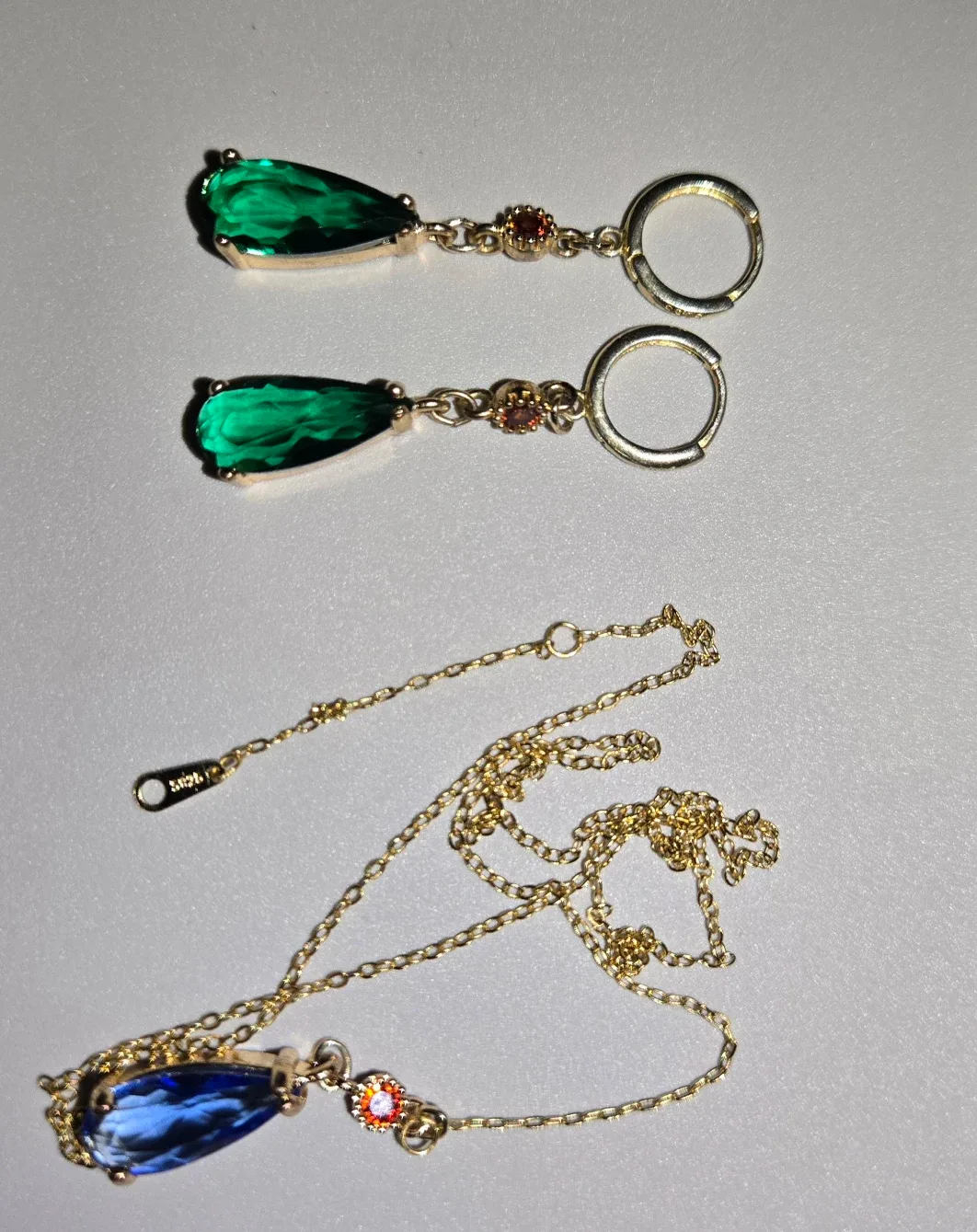 silver jewelry with emerald-type stones image indicator(2)