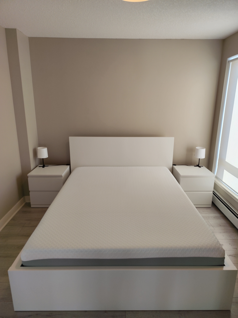 White Bed Frame with 2 Nightstands and a foam