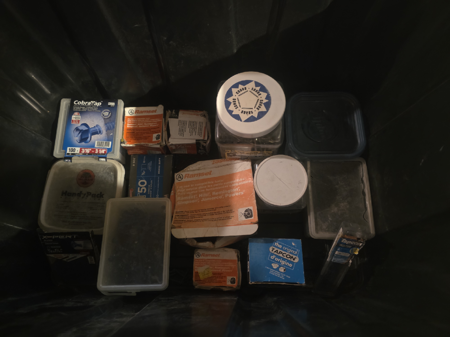Black container full of concrete screws and Ramset shot nails - photo 2